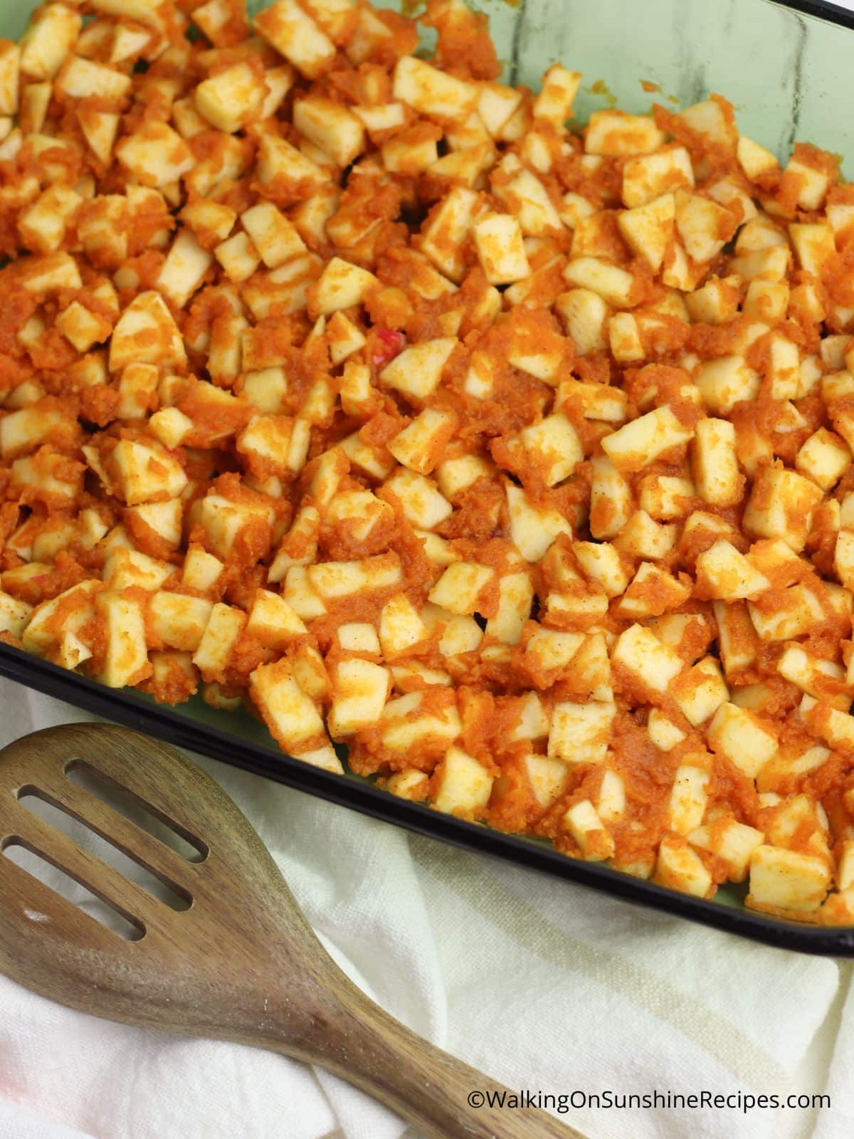 chopped apples with pumpkin puree in casserole dish.