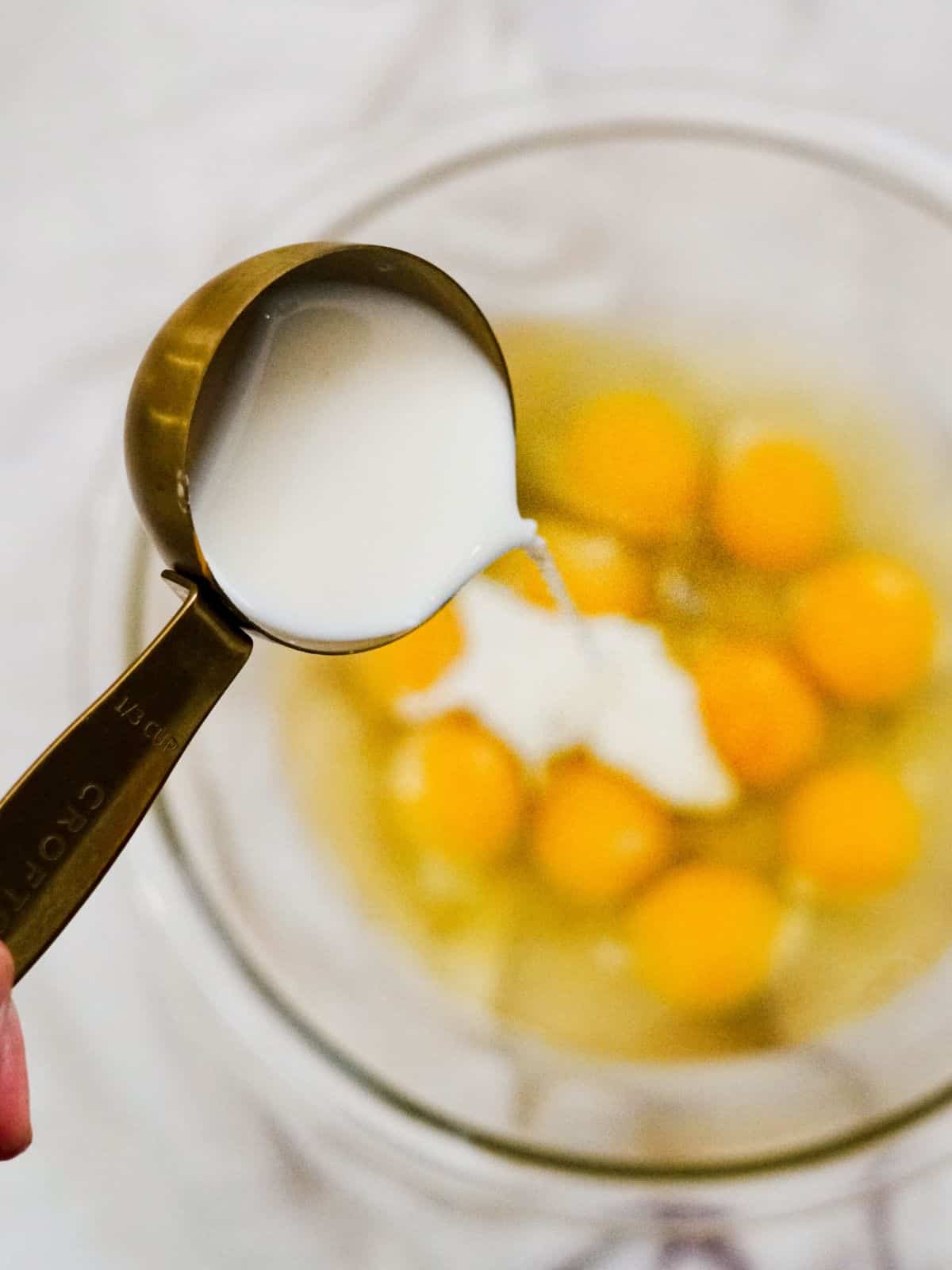 Add milk to scrambled eggs.