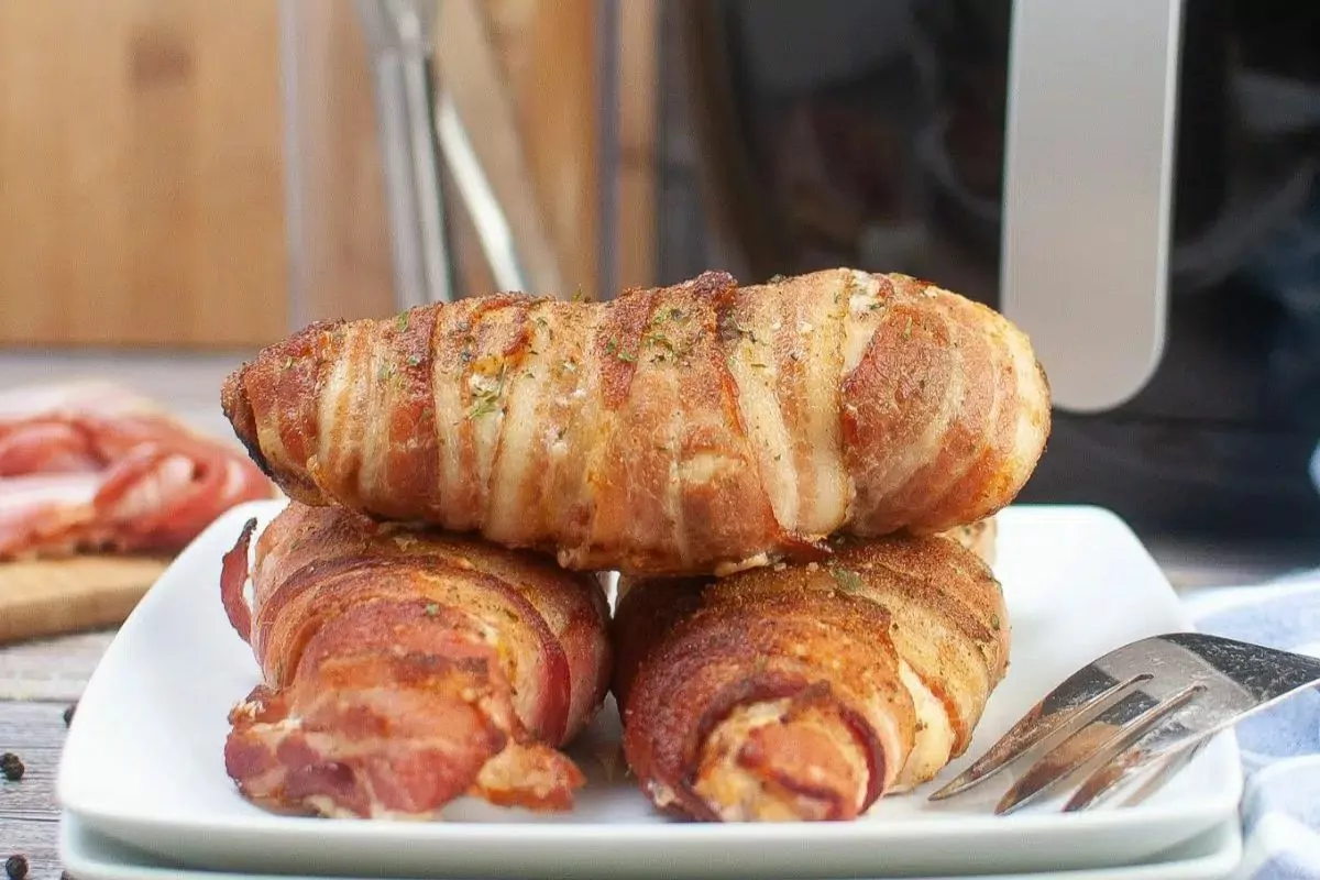 Bacon-wrapped chicken breasts on a plate.