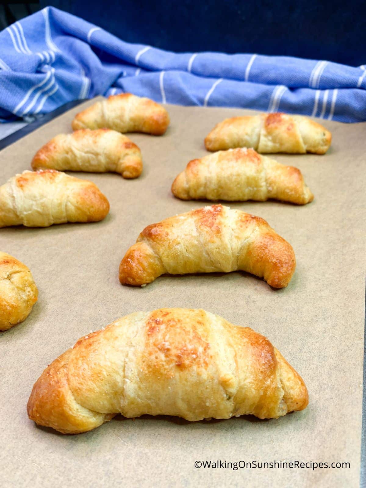 baked crescent rolls on baking sheet with parchment paper.