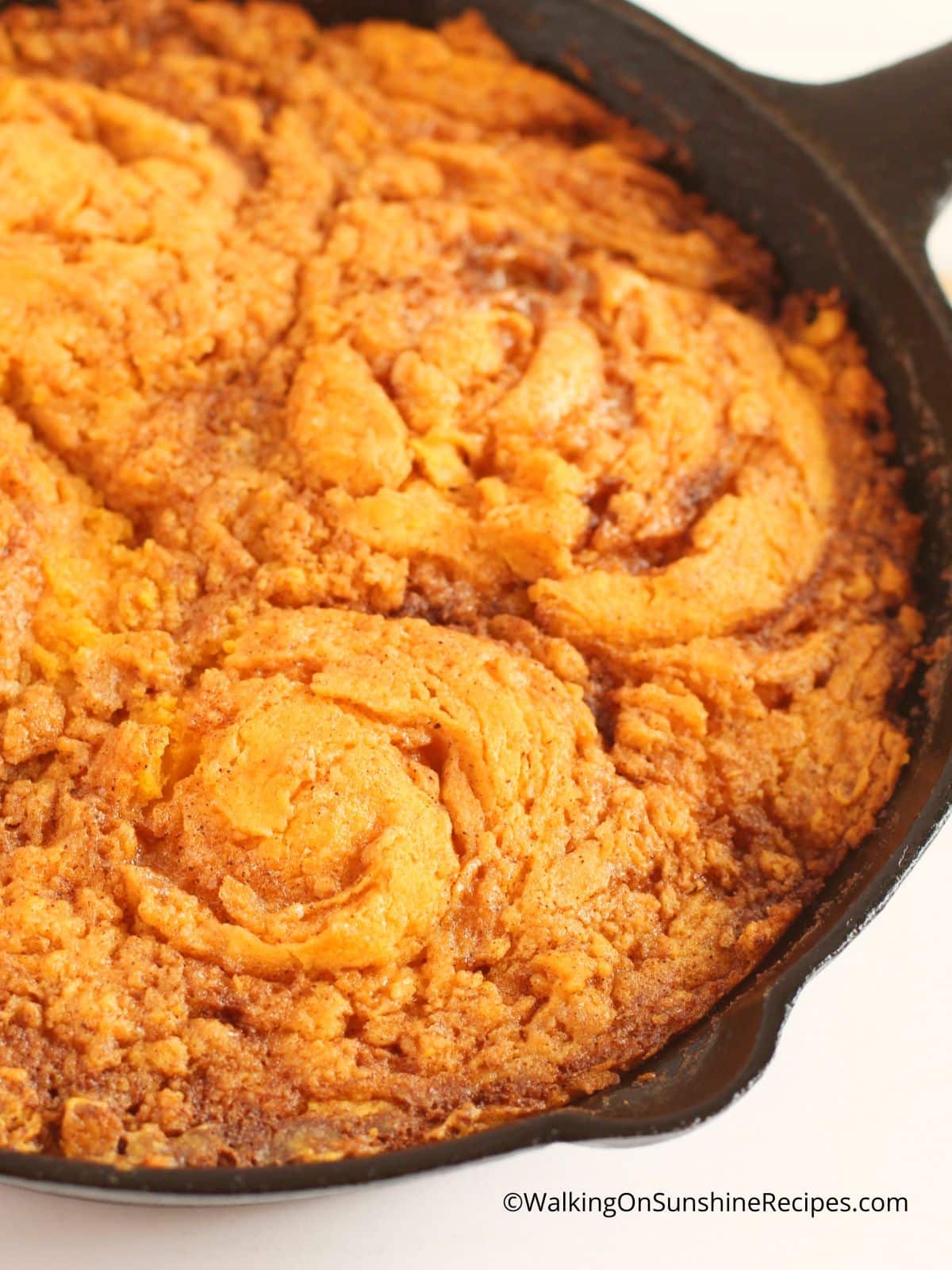 Baked pumpkin coffee cake in cast iron skillet.