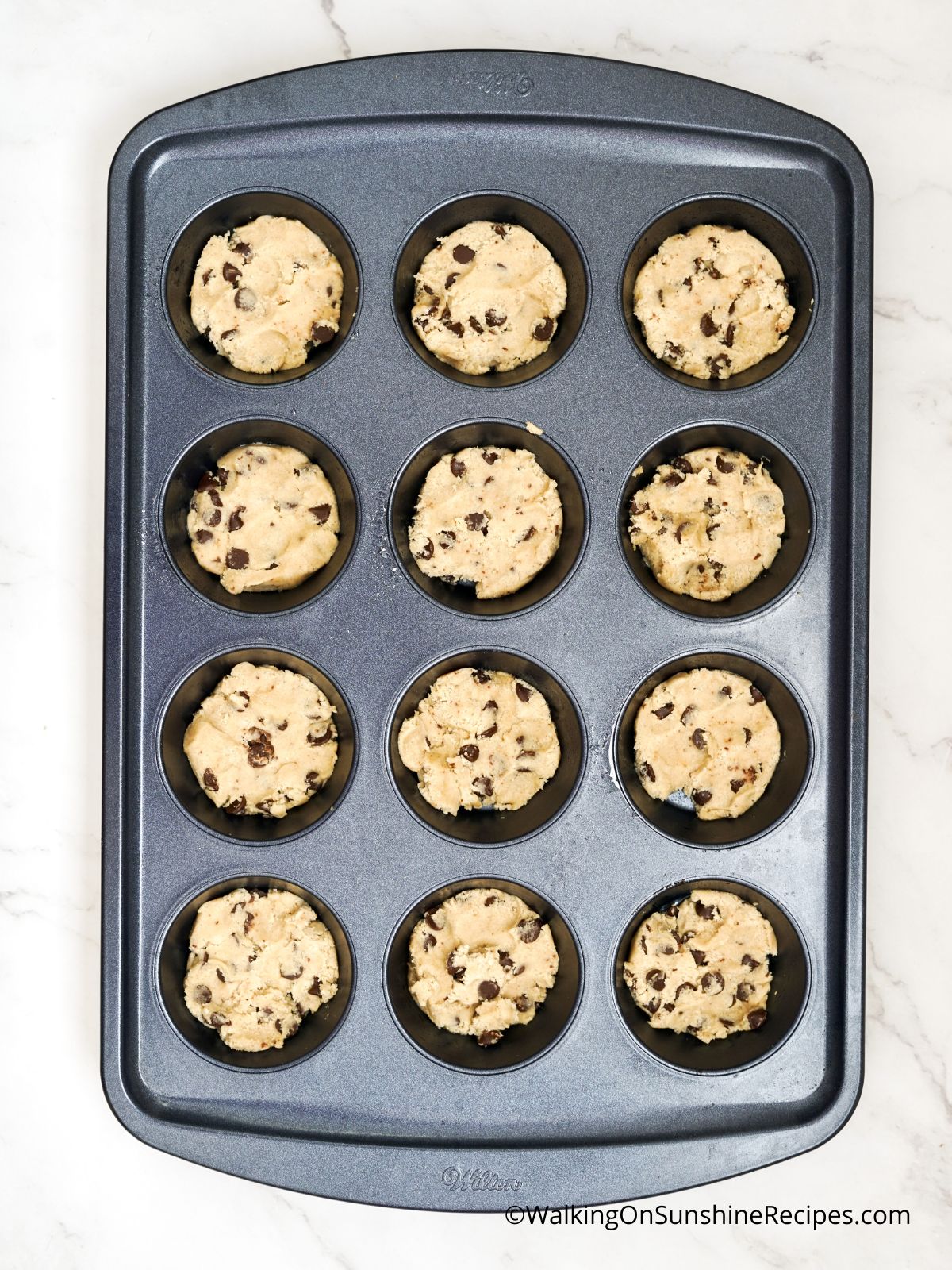 chocolate chip cookie dough in muffin pan.
