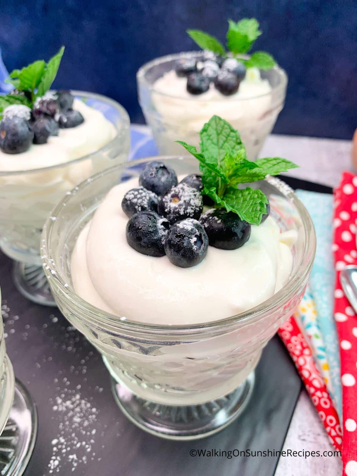Closeup of Weight Watchers cheesecake pudding in glass cup with blueberries on top.