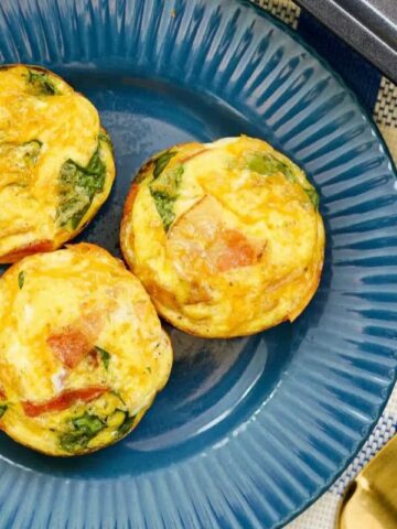 Three egg bites on a blue plate.