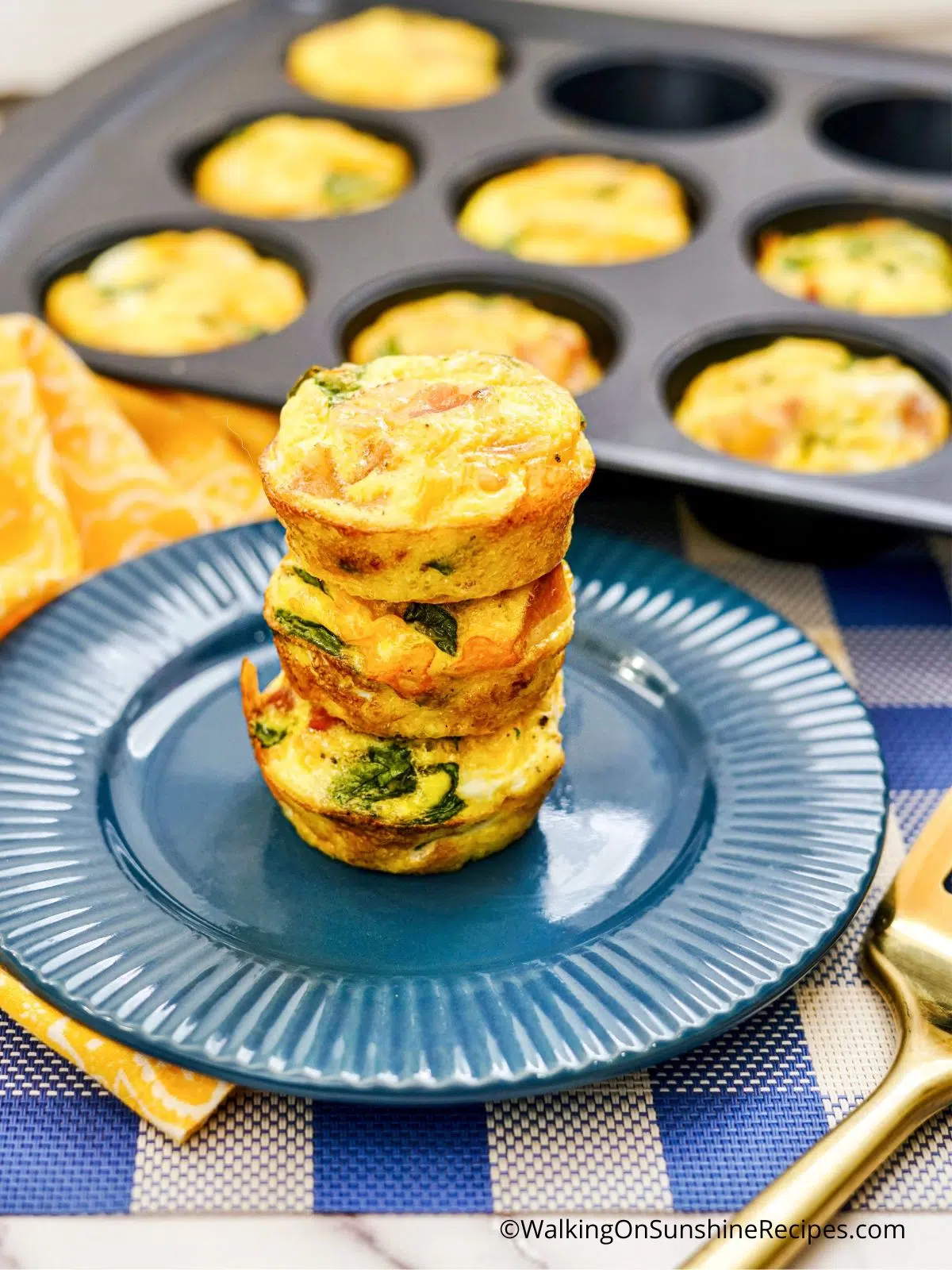 scrambled egg muffins stacked on blue plate.