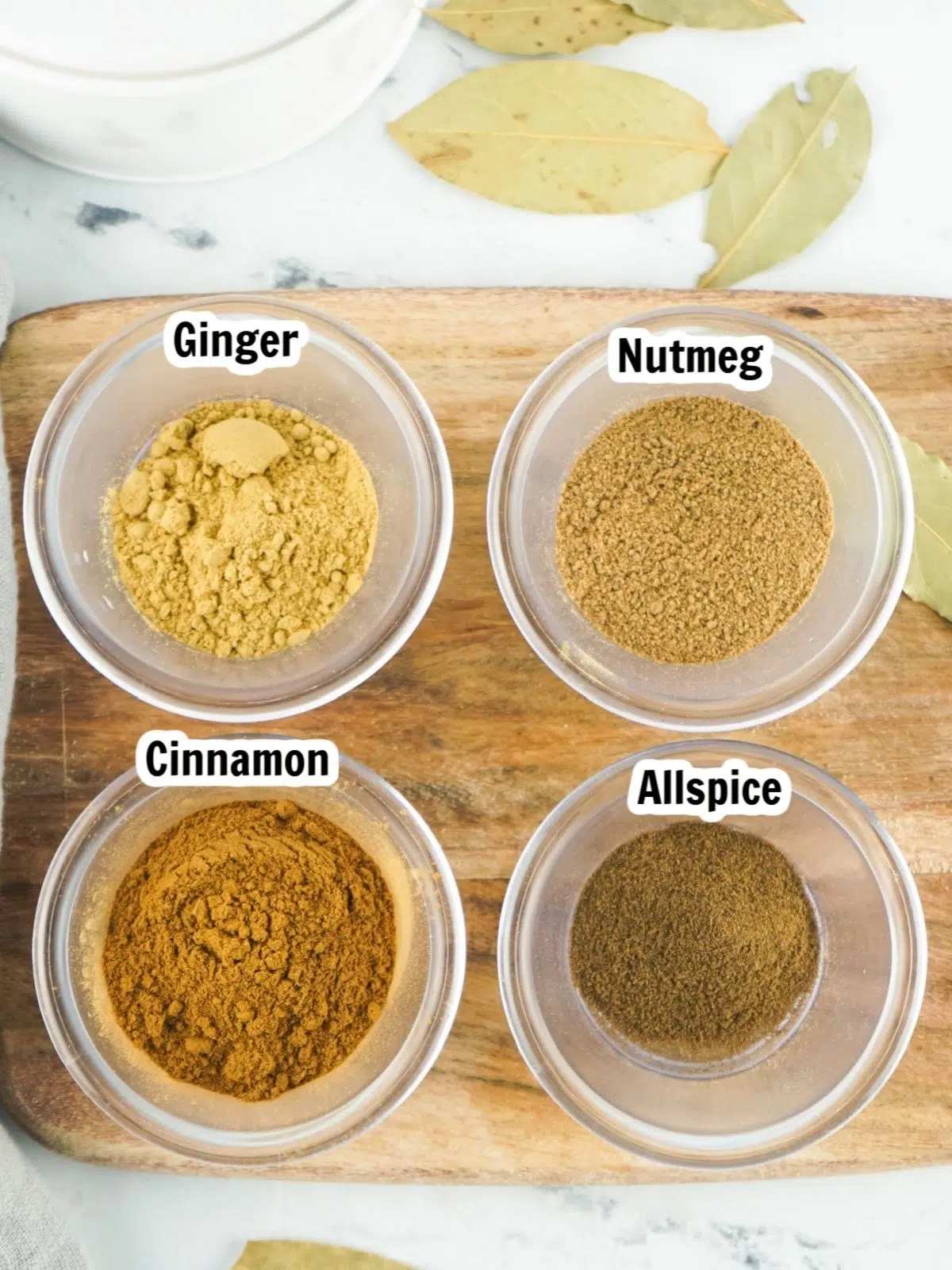 Ingredients for pumpkin pie spice mix in glass jars.