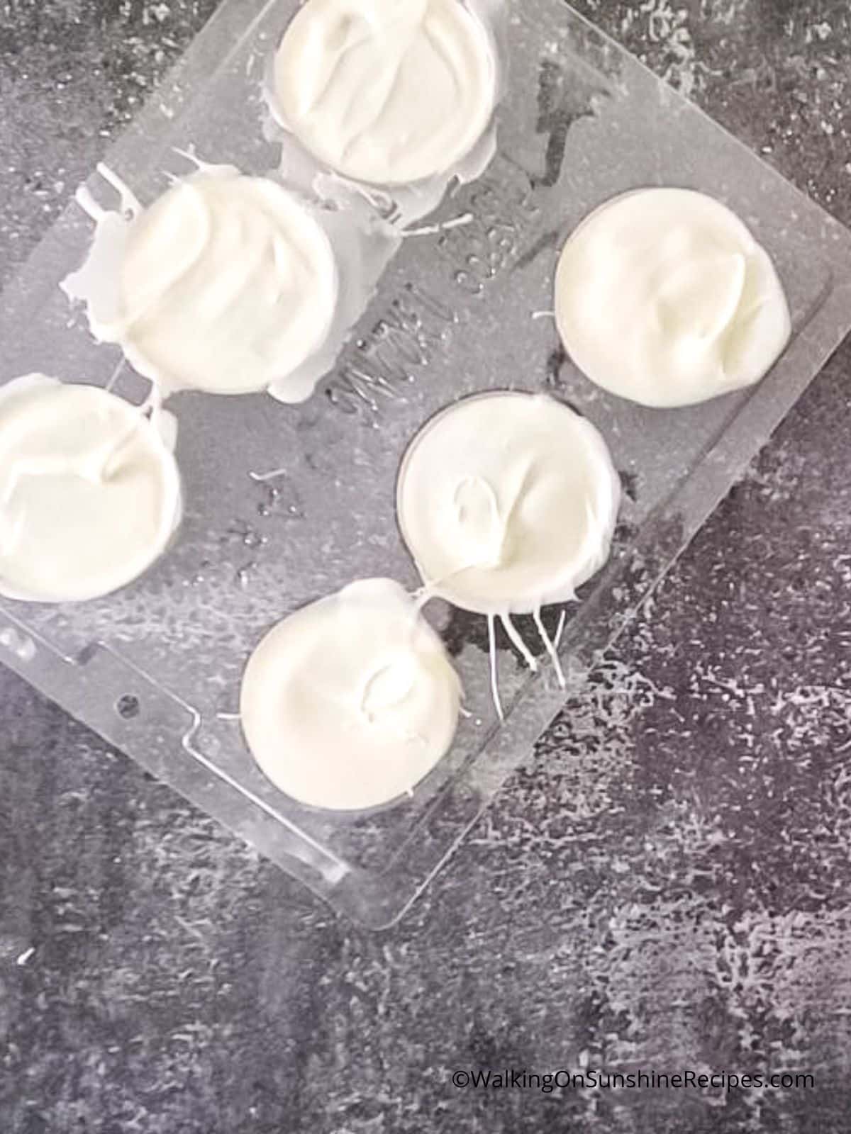 white chocolate covered Oreo cookies in mold.