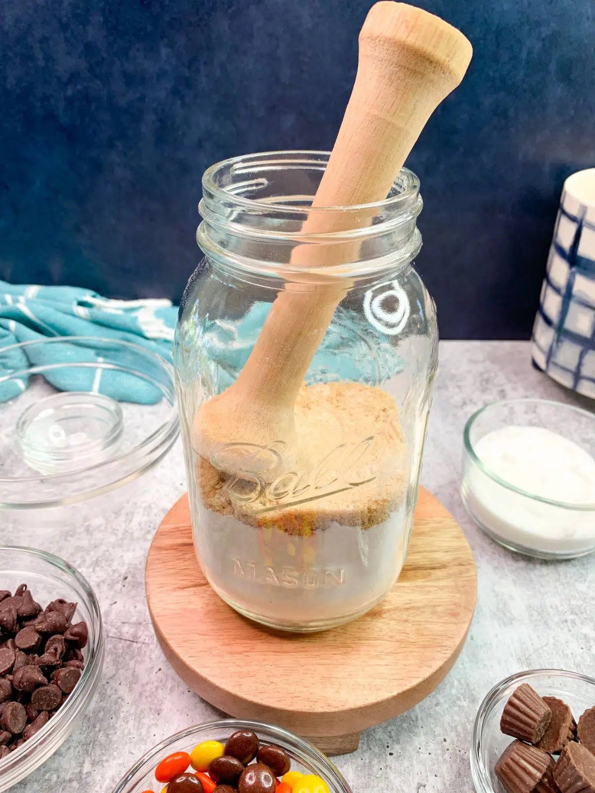 Use tamper tart tool to even out ingredients in mason jar.
