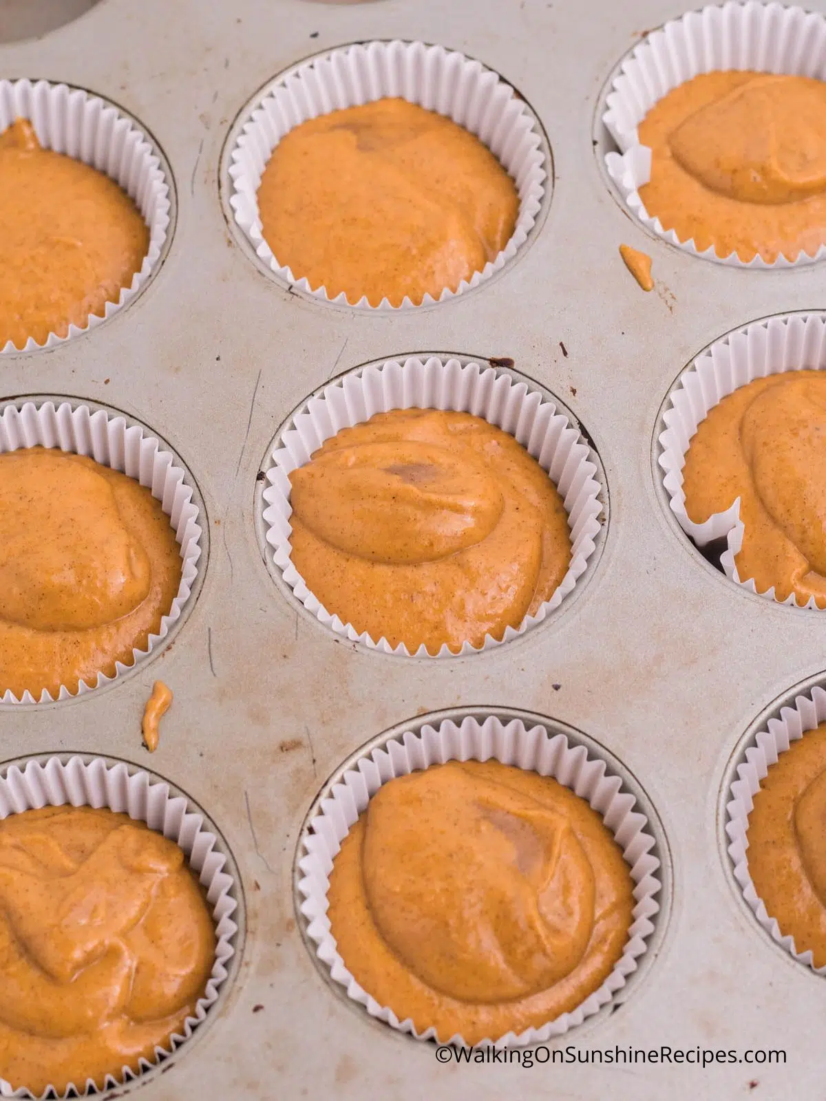 pumpkin muffins in muffin pan unbaked.