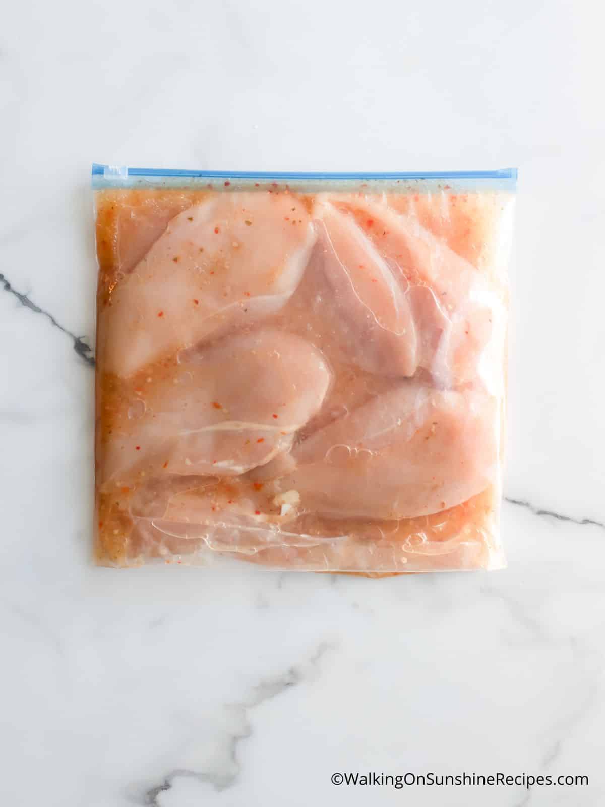 chicken cutlets in plastic bag with Italian dressing marinade.