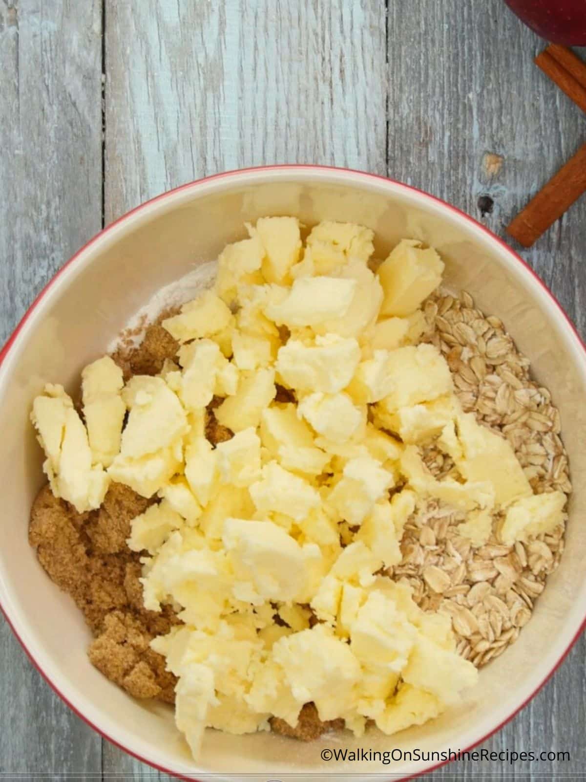 Add butter to the topping for apple crisp.