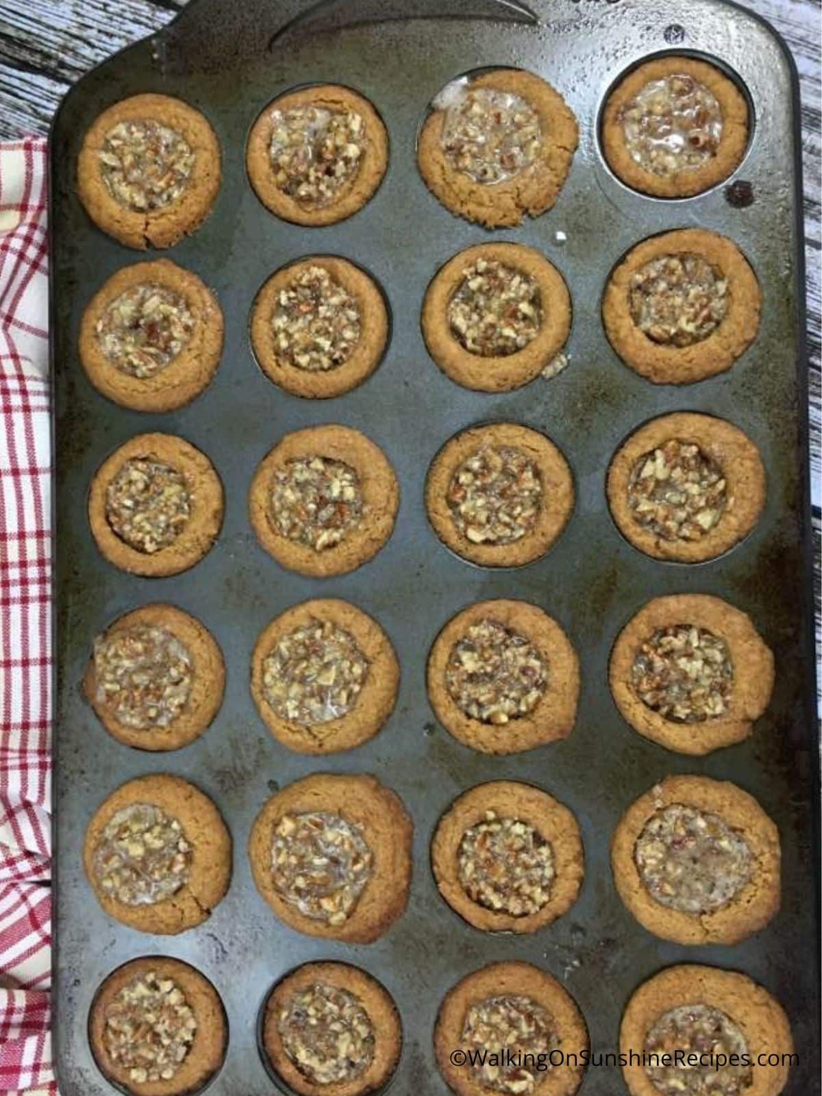 baked pecan spice cookie cups in mini muffin pan.