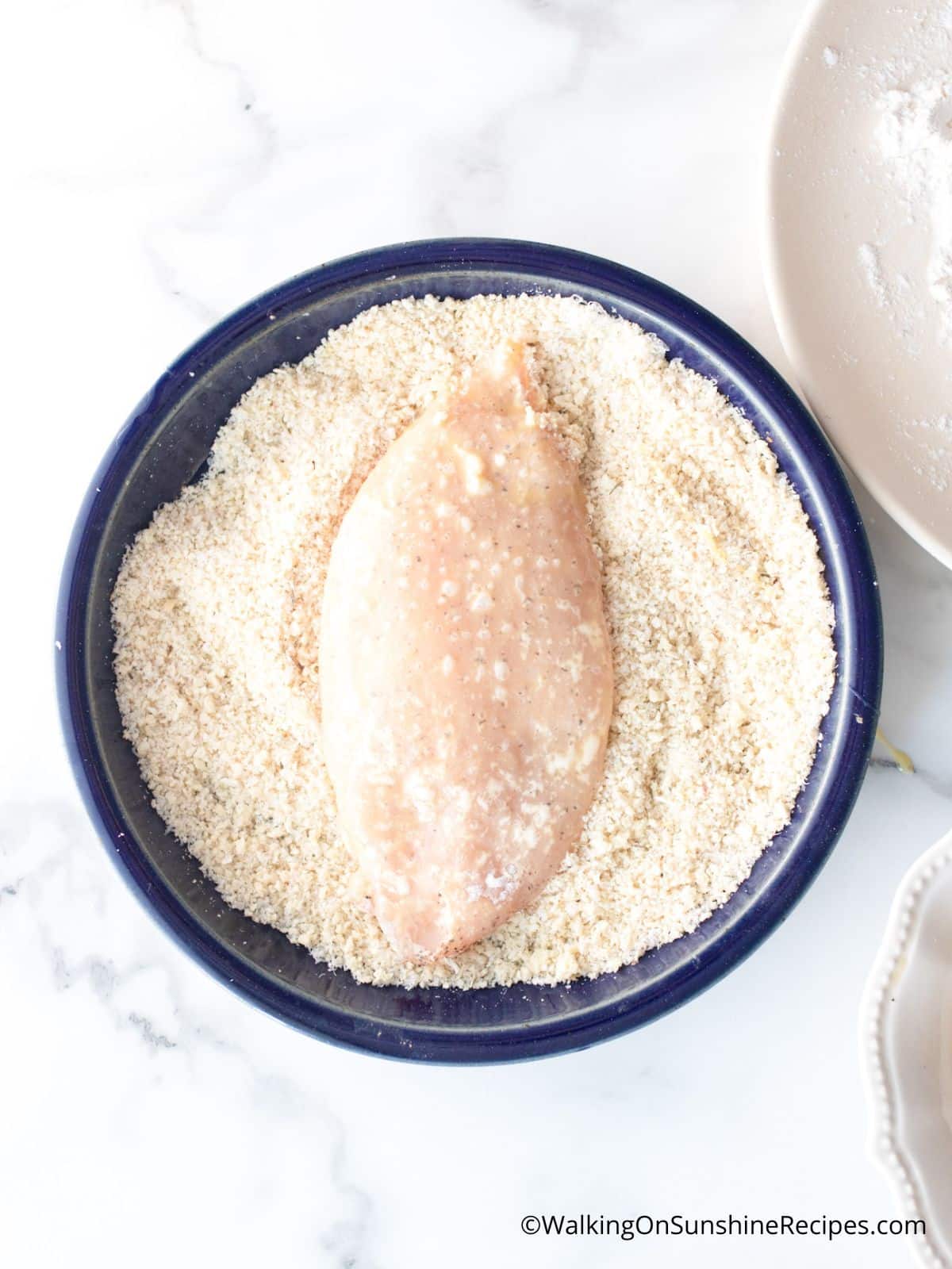 Add chicken cutlet to pank breadcrumbs.