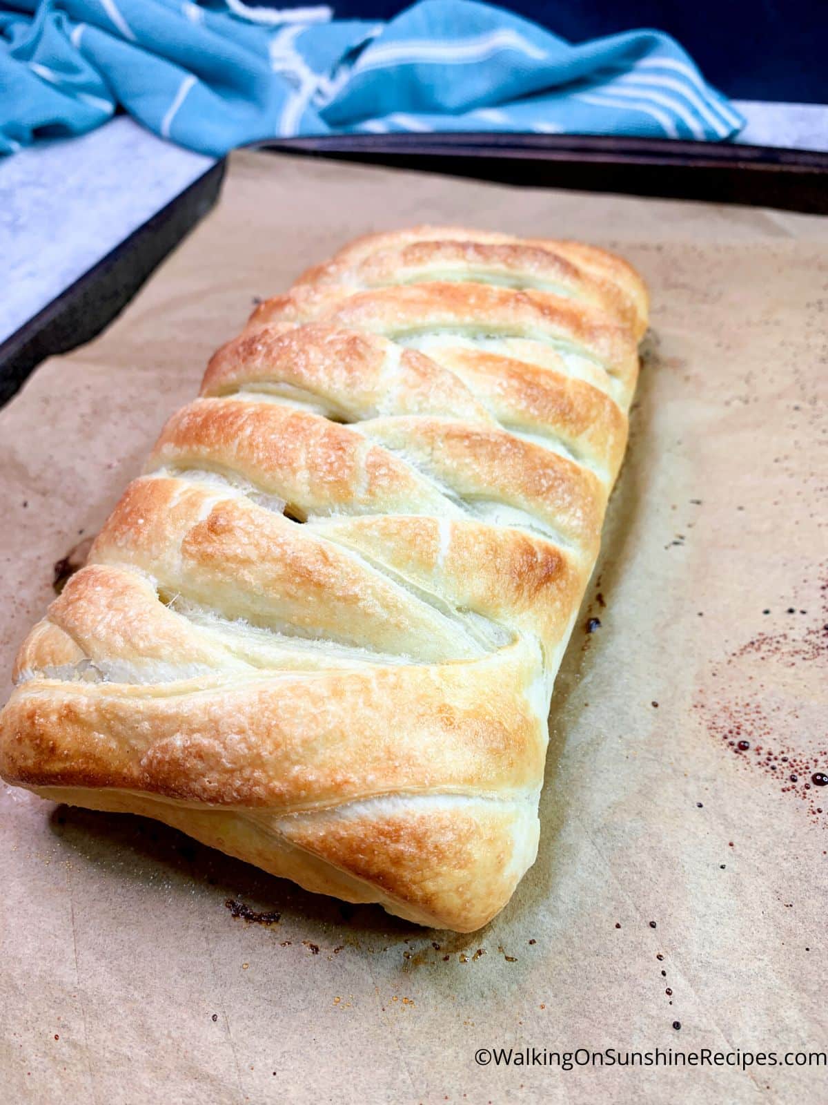baked puff pastry braid on baking tray.