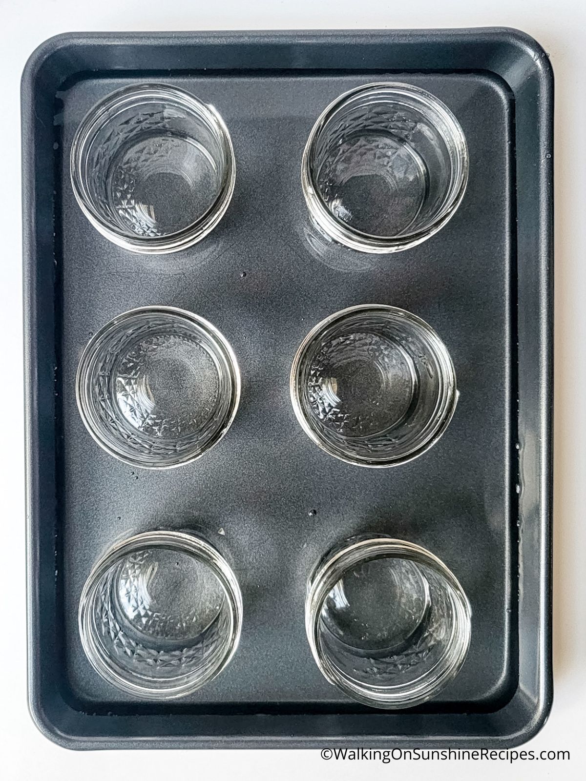Mason jars in baking pan.