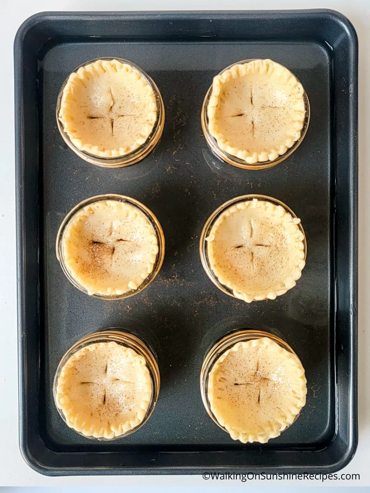 mini apple pies in mason jars before baking.