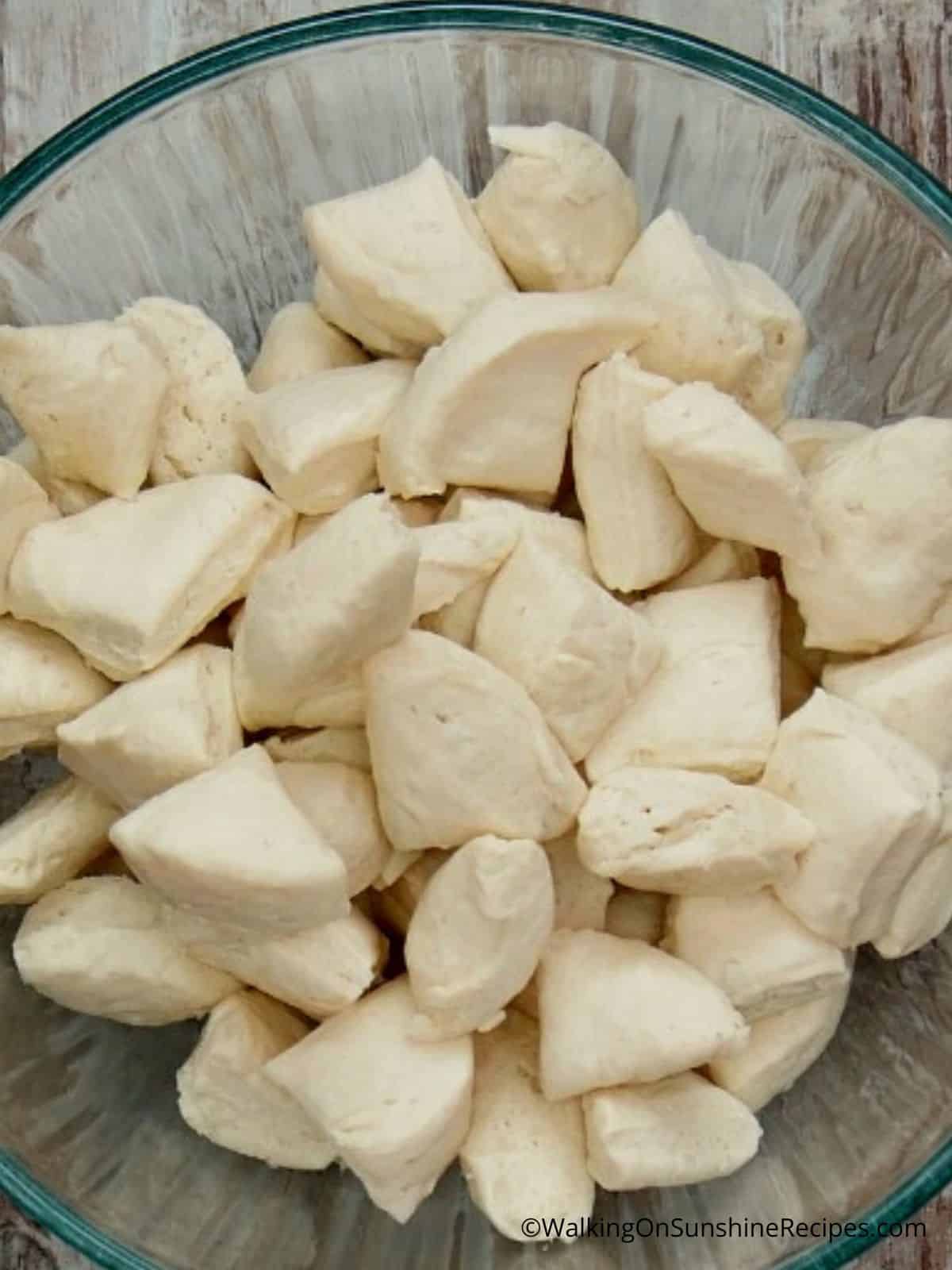 refrigerator biscuits cut into pieces in a bowl.