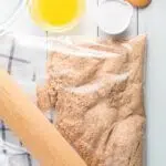 Graham crackers in bag with rolling pin.