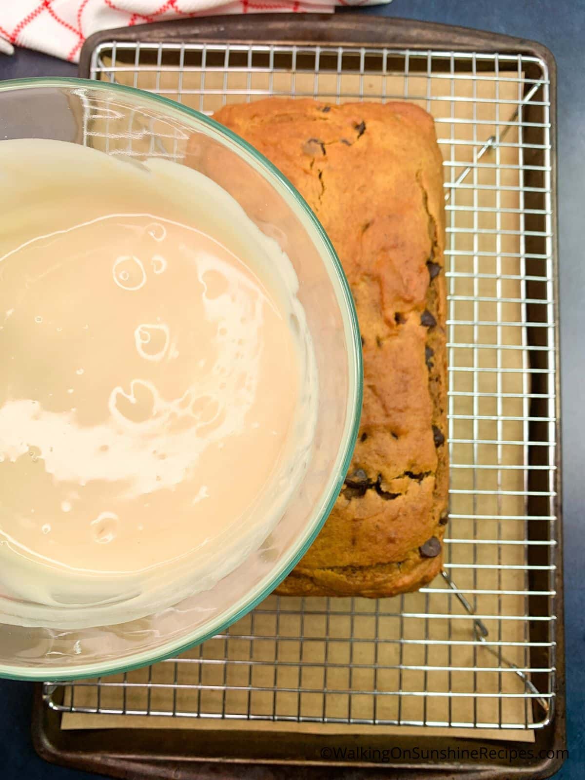 Pour maple sugar glaze on top of baked pumpkin bread.