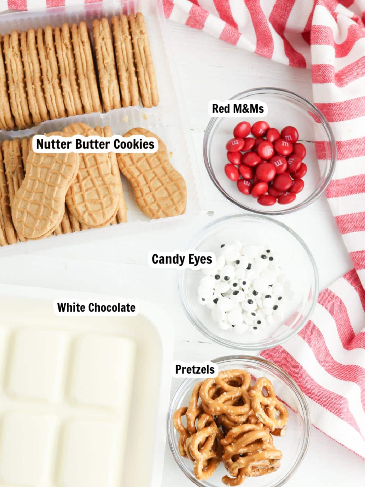 Ingredients, pretzels, white chocolate, candy eyes, candy pieces, nutter butter cookies.