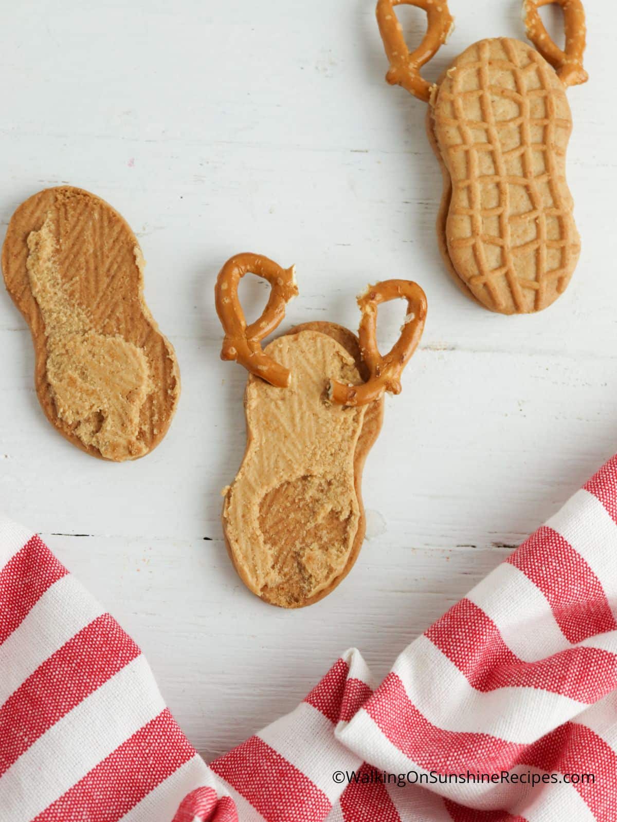 Attach pretzels to inside of cookies.