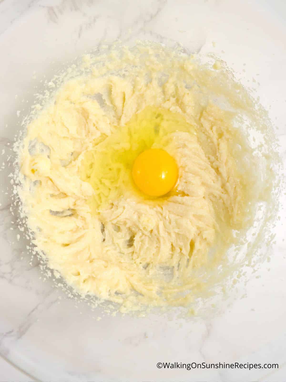 egg in sugar and butter mixture.