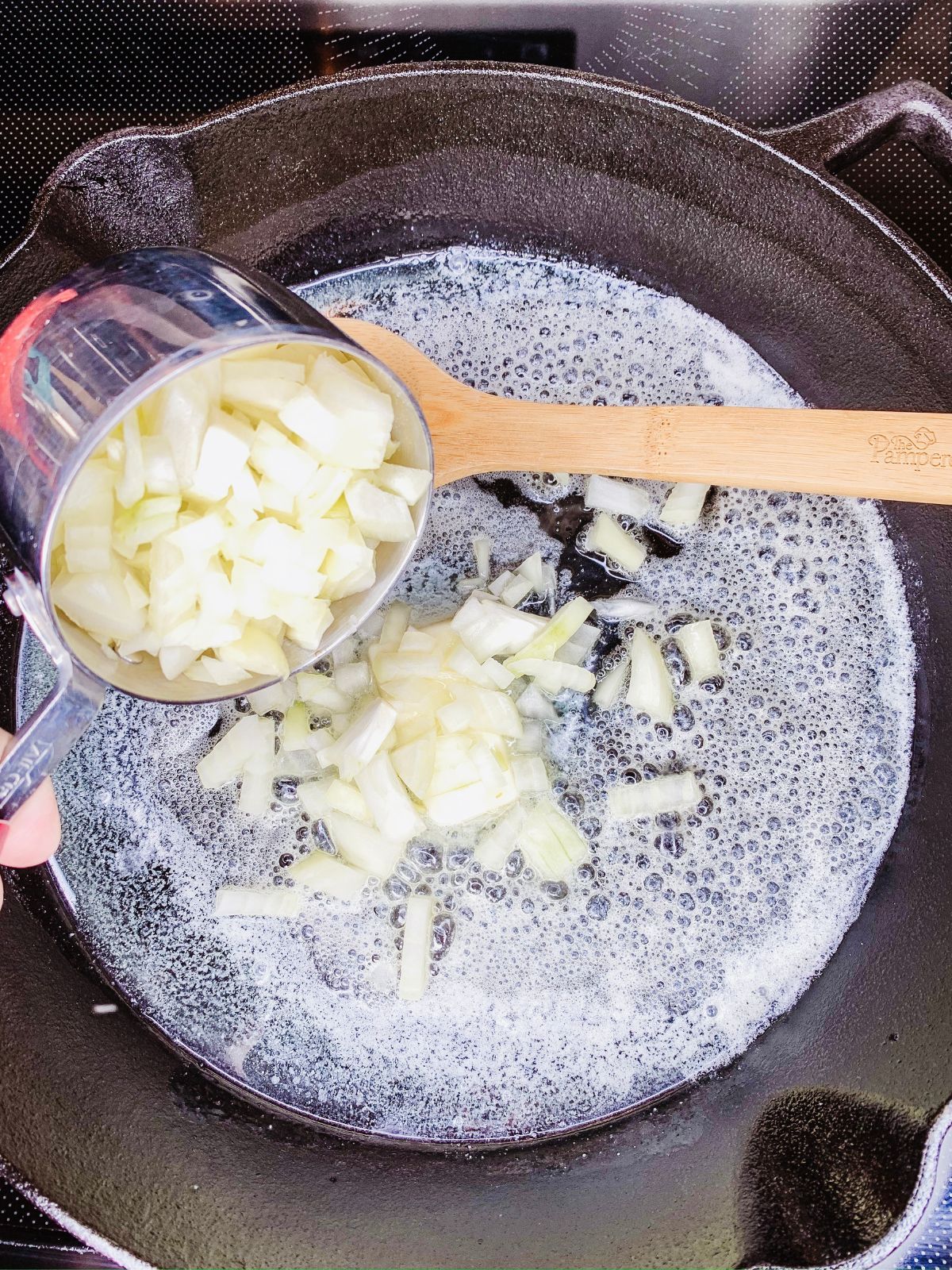 Cook chopped onions in butter in cast iron skillet.