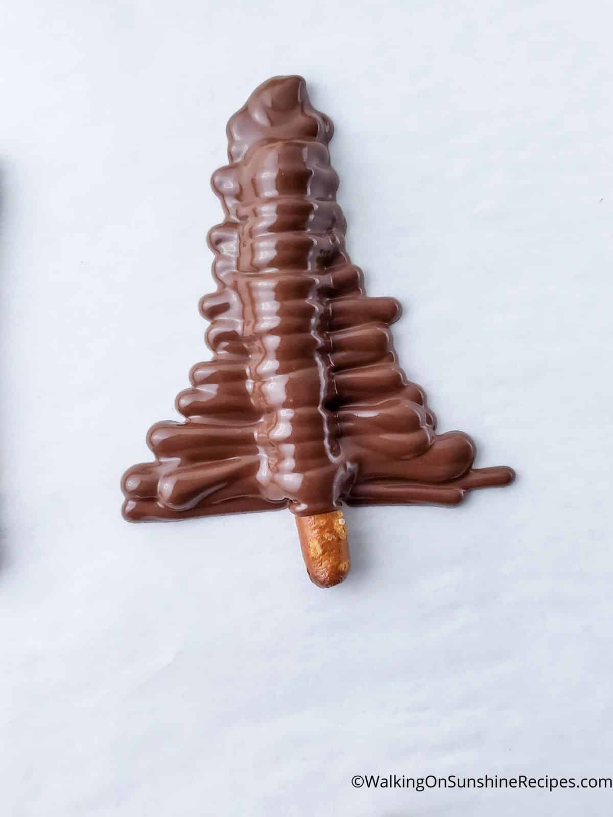 pretzel stick covered with melted chocolate to look like a Christmas tree.