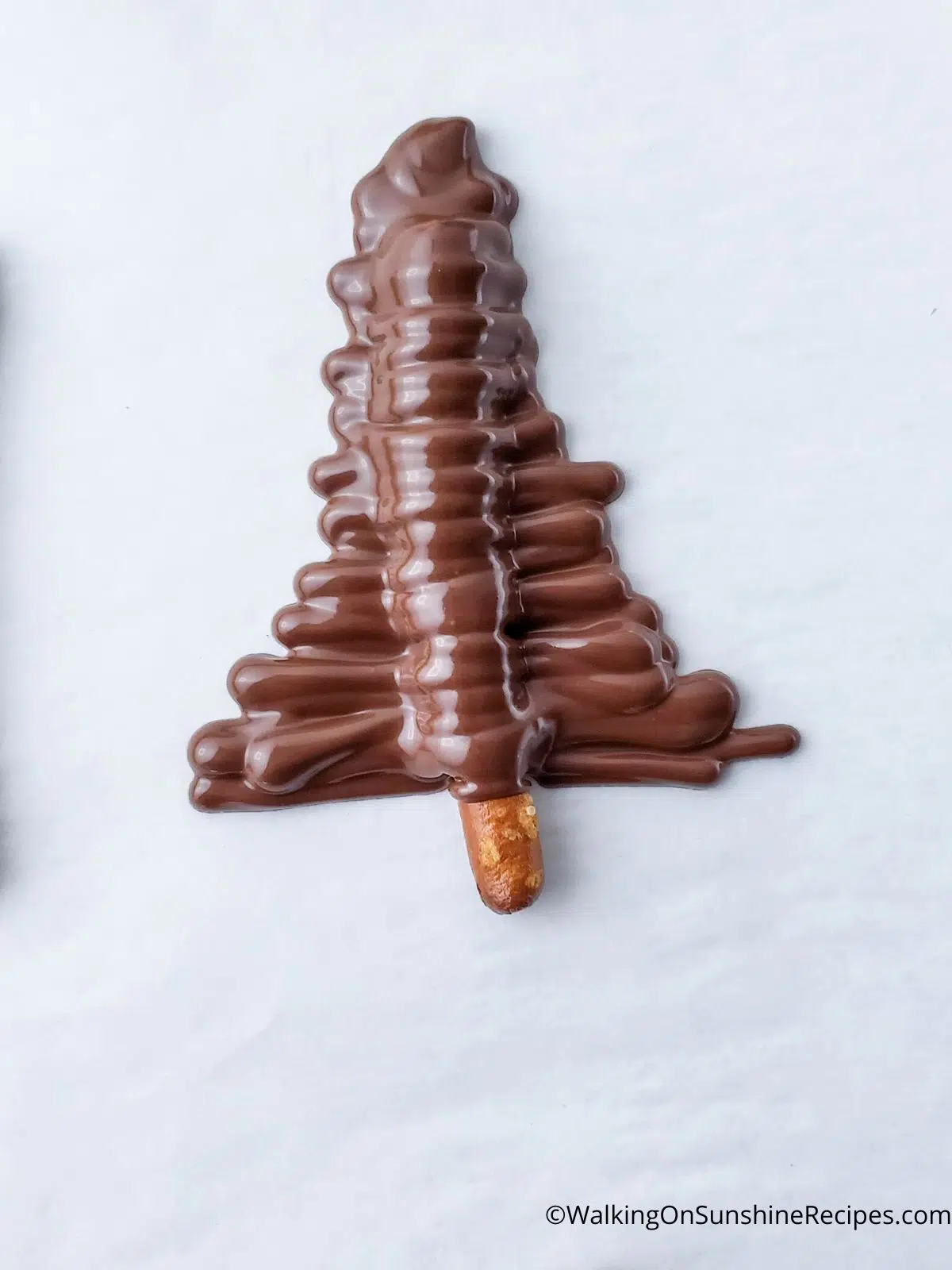 pretzel stick covered with melted chocolate to look like a Christmas tree.