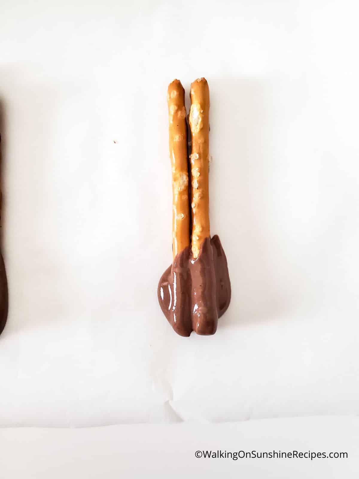 pretzel sticks in melted chocolate.