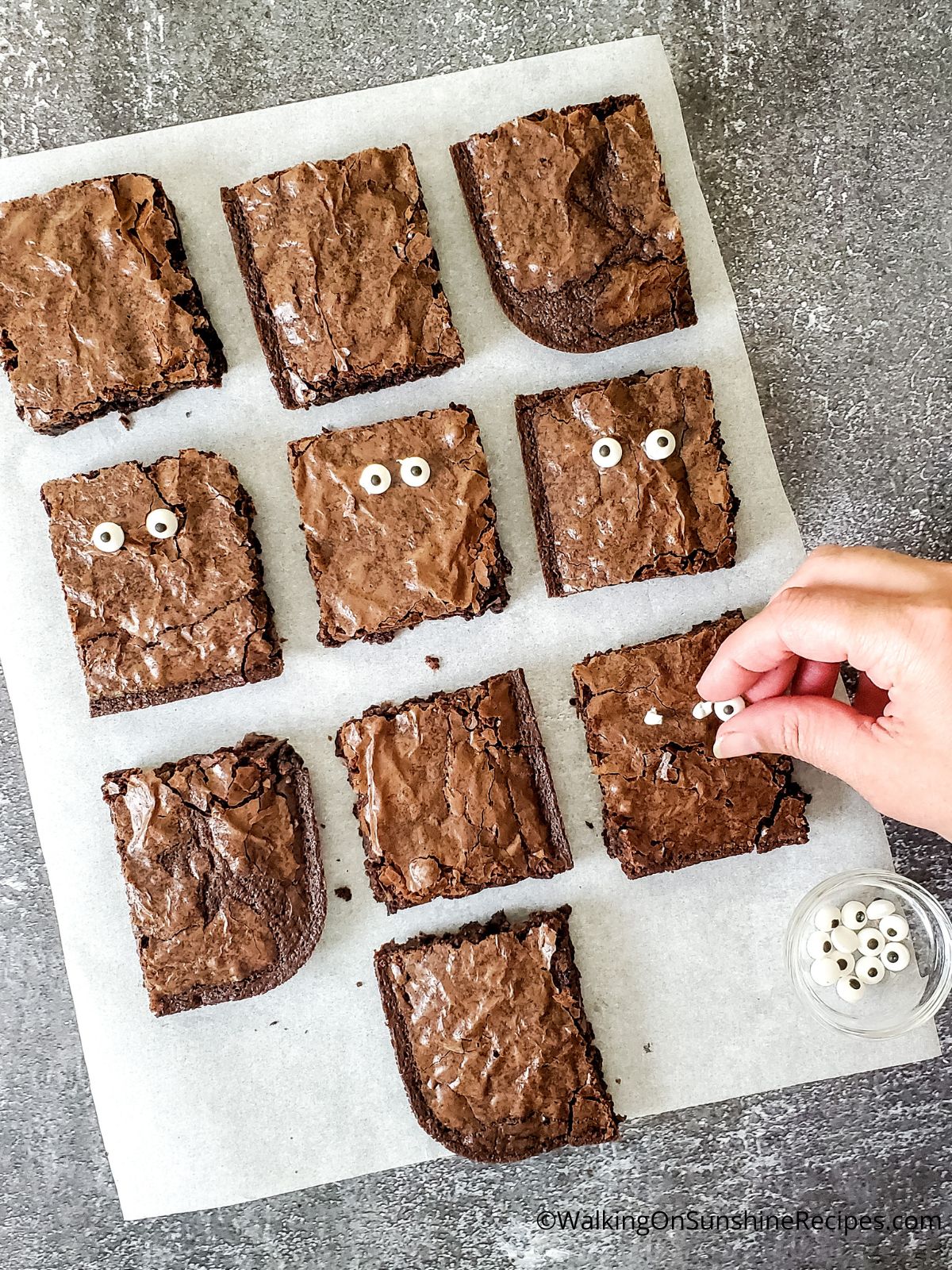 Add candy eyes to brownies.