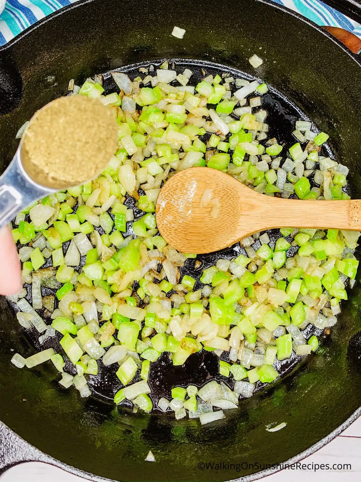 Add poultry seasoning to cast iron skillet with onions and celery.