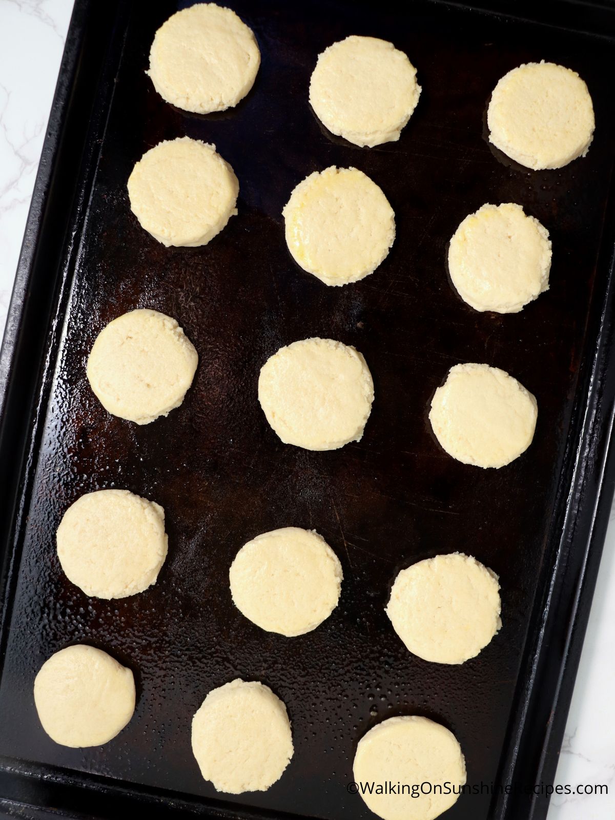 Sugar cookies baked on tray.