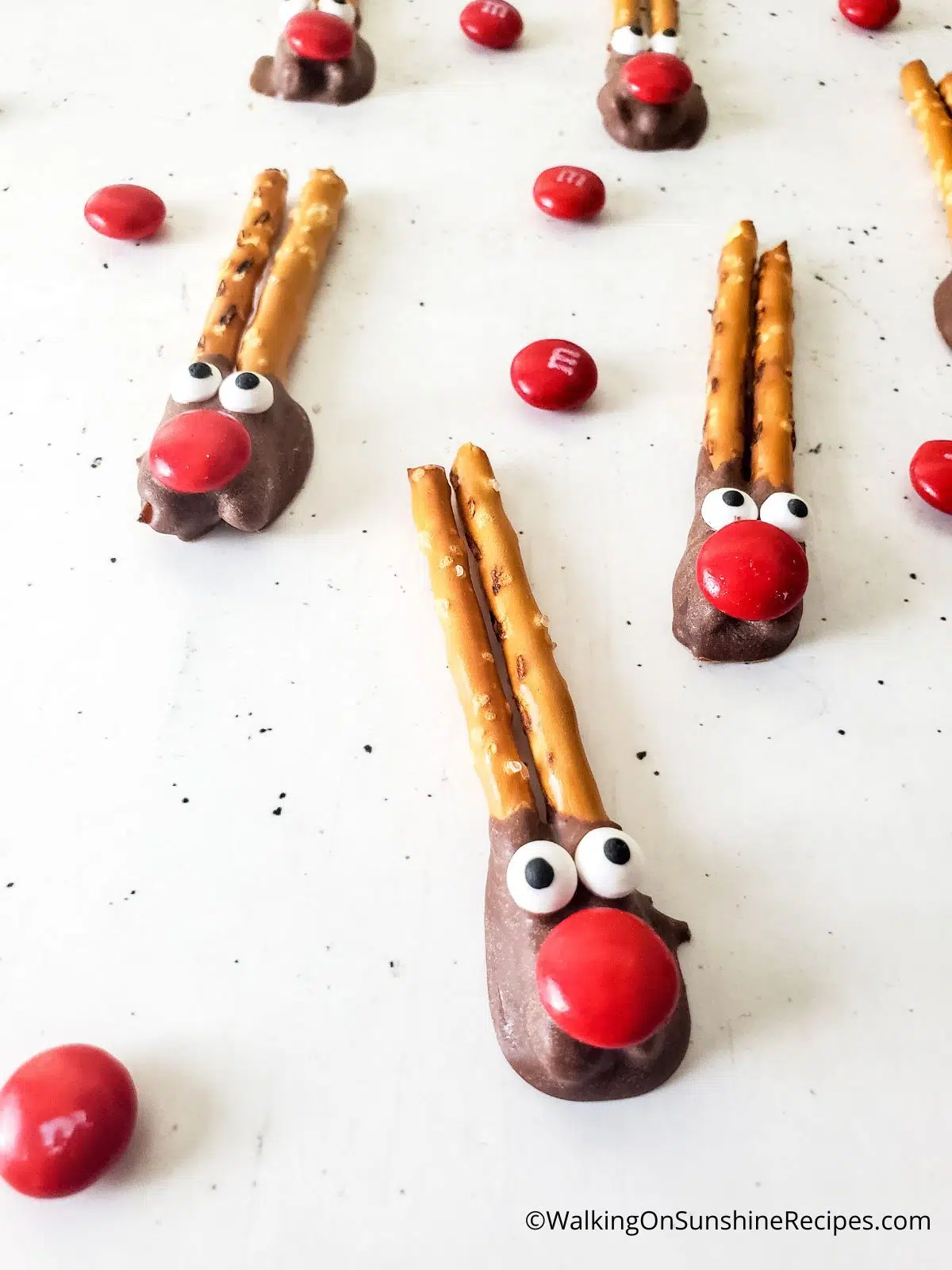 reindeer snacks made with pretzel sticks, candy eyes and melted chocolate.
