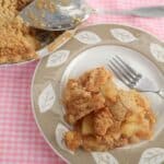 apple crumb pie sliced and served on plate with fork.