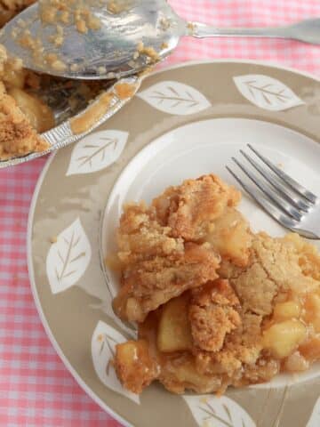 apple crumb pie sliced and served on plate with fork.
