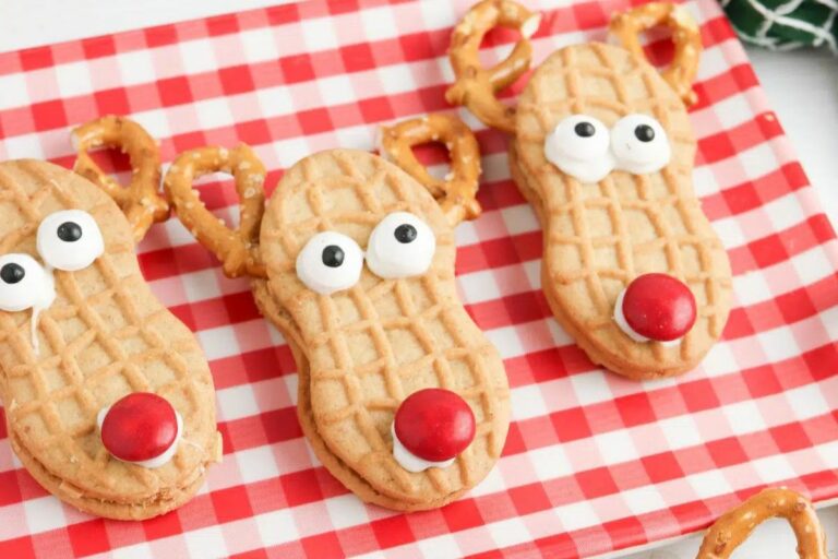 Peanut butter cookies transformed into adorable reindeer with pretzel antlers and candy eyes.