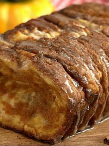 loaf of Pumpkin Spice Pull Apart Bread on a wood cutting board