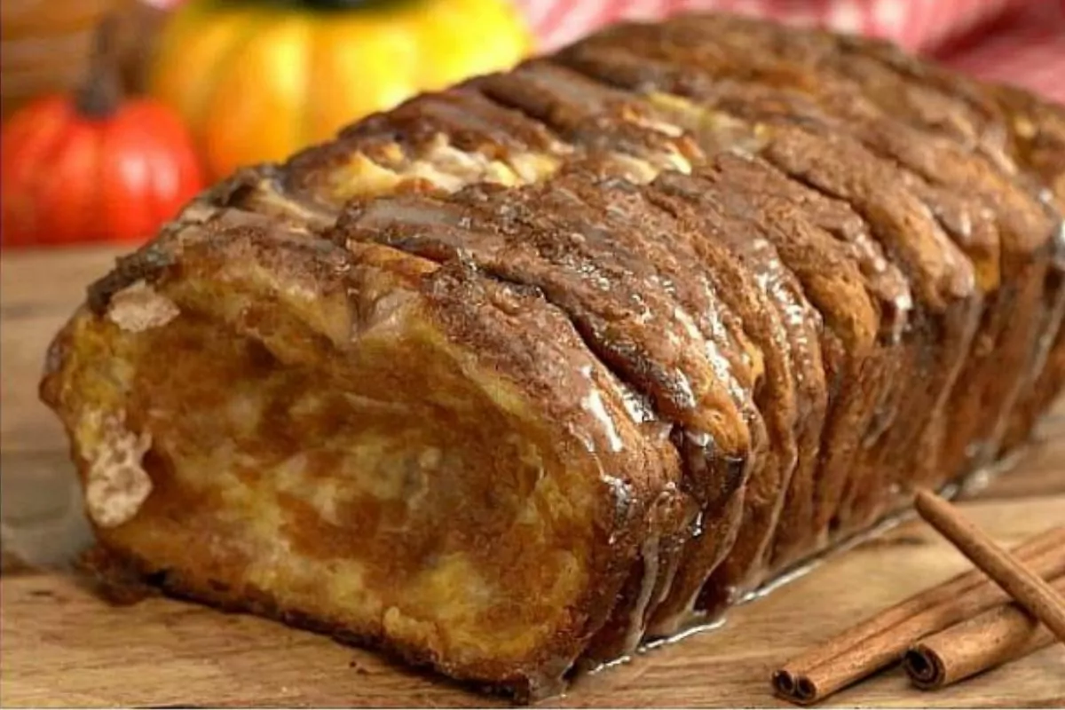 loaf of Pumpkin Spice Pull Apart Bread on a wood cutting board