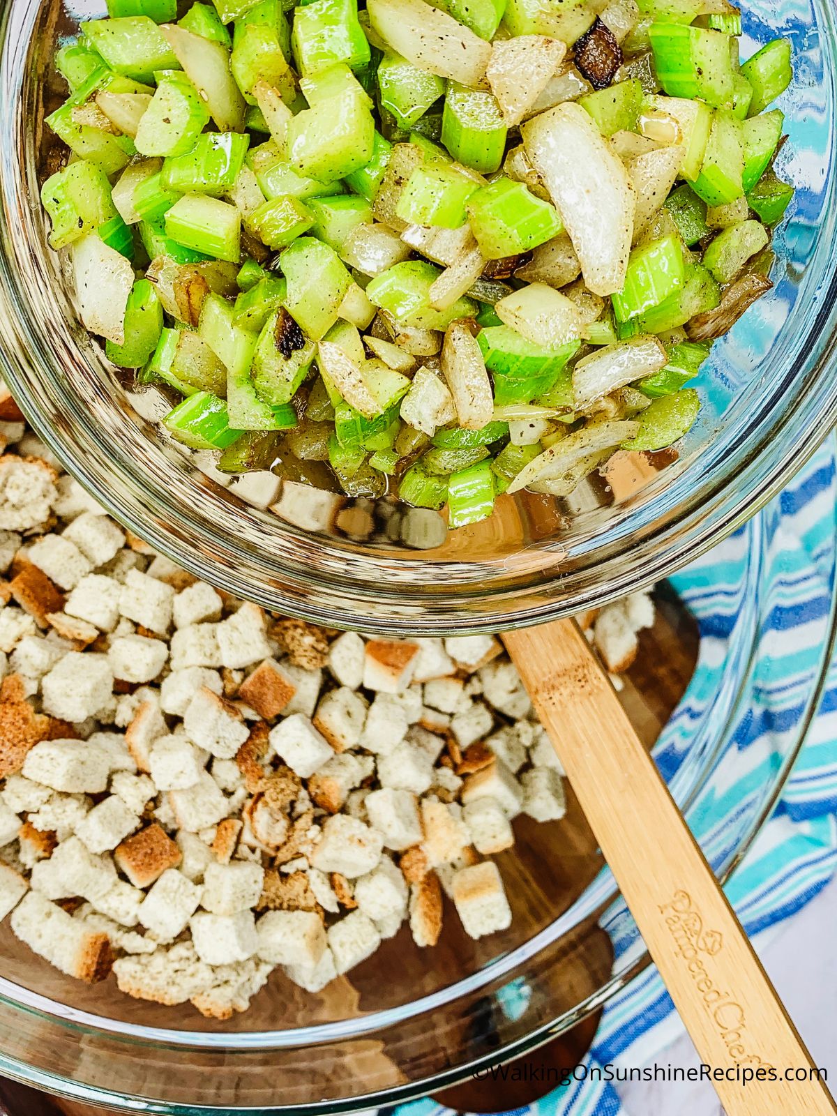 add celery and onion to stuffing cubes in bowl.