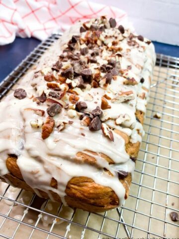 Top pumpkin bread with chopped walnuts and chocolate chips.