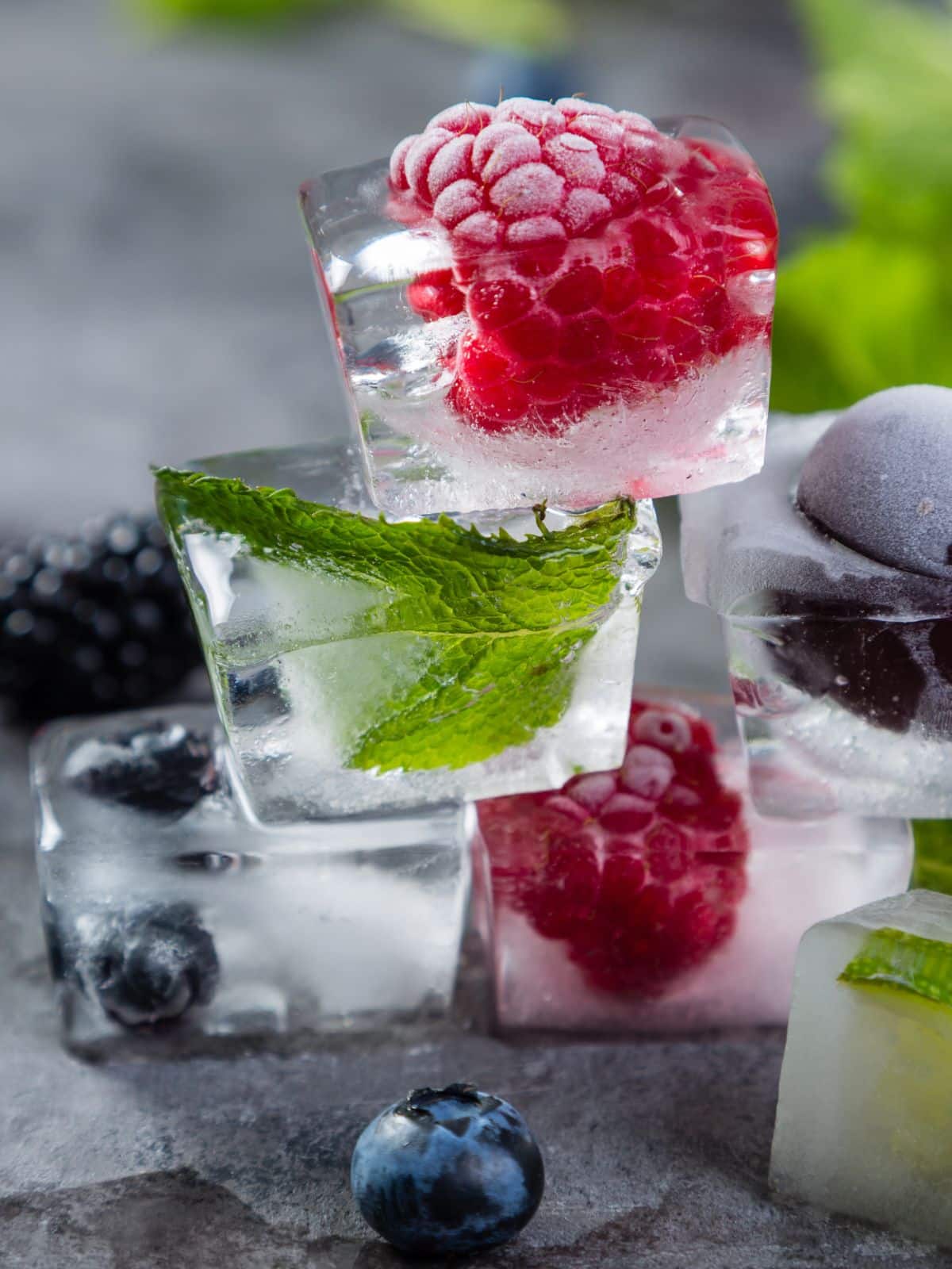 frozen blueberries, raspberries and mint in ice cubes.