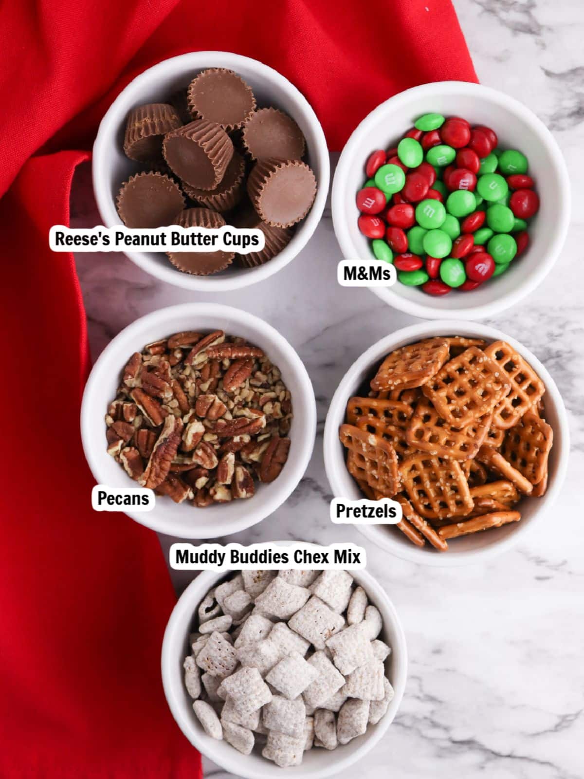ingredients for Christmas snack mix in a jar.