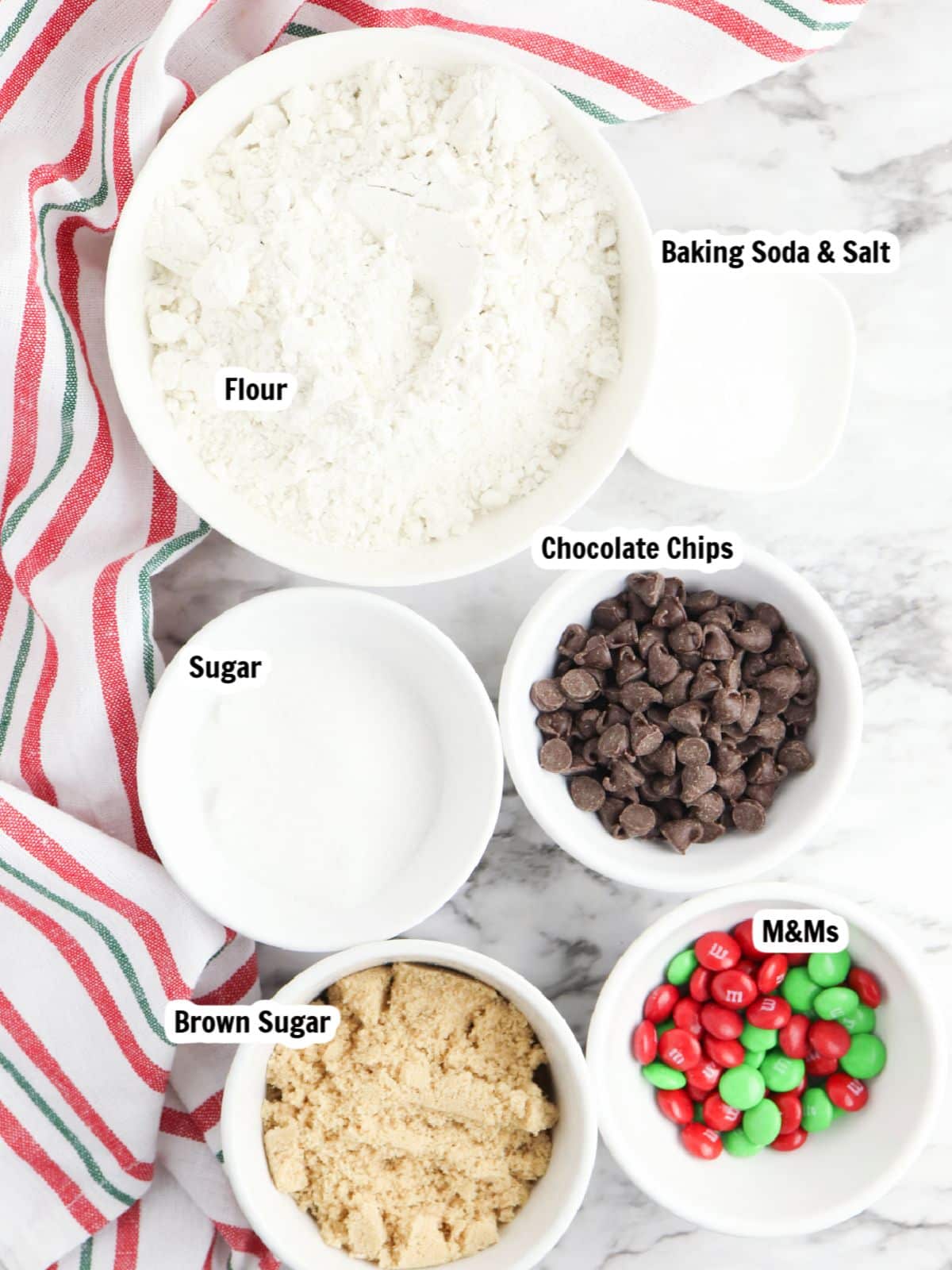 ingredients for cookies with chocolate chips and red and green M&Ms.