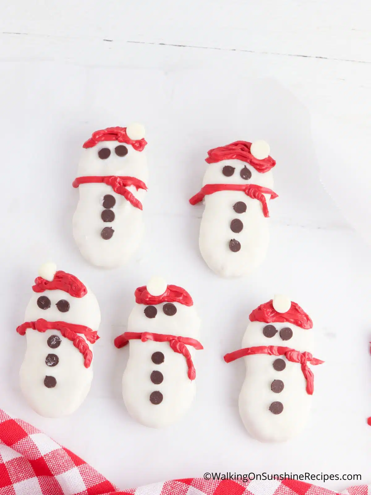 snowmen nutter butter cookies on white plate.