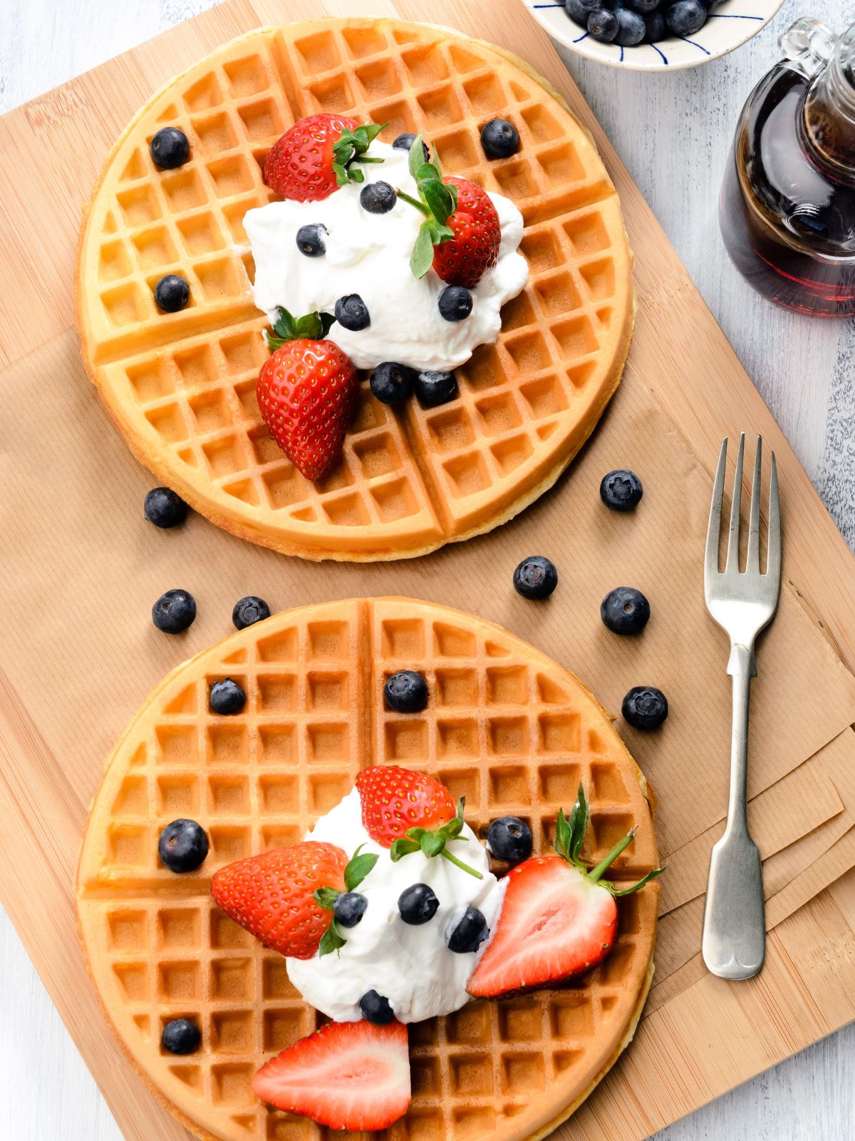 waffles with whipped cream, strawberries and blueberries.