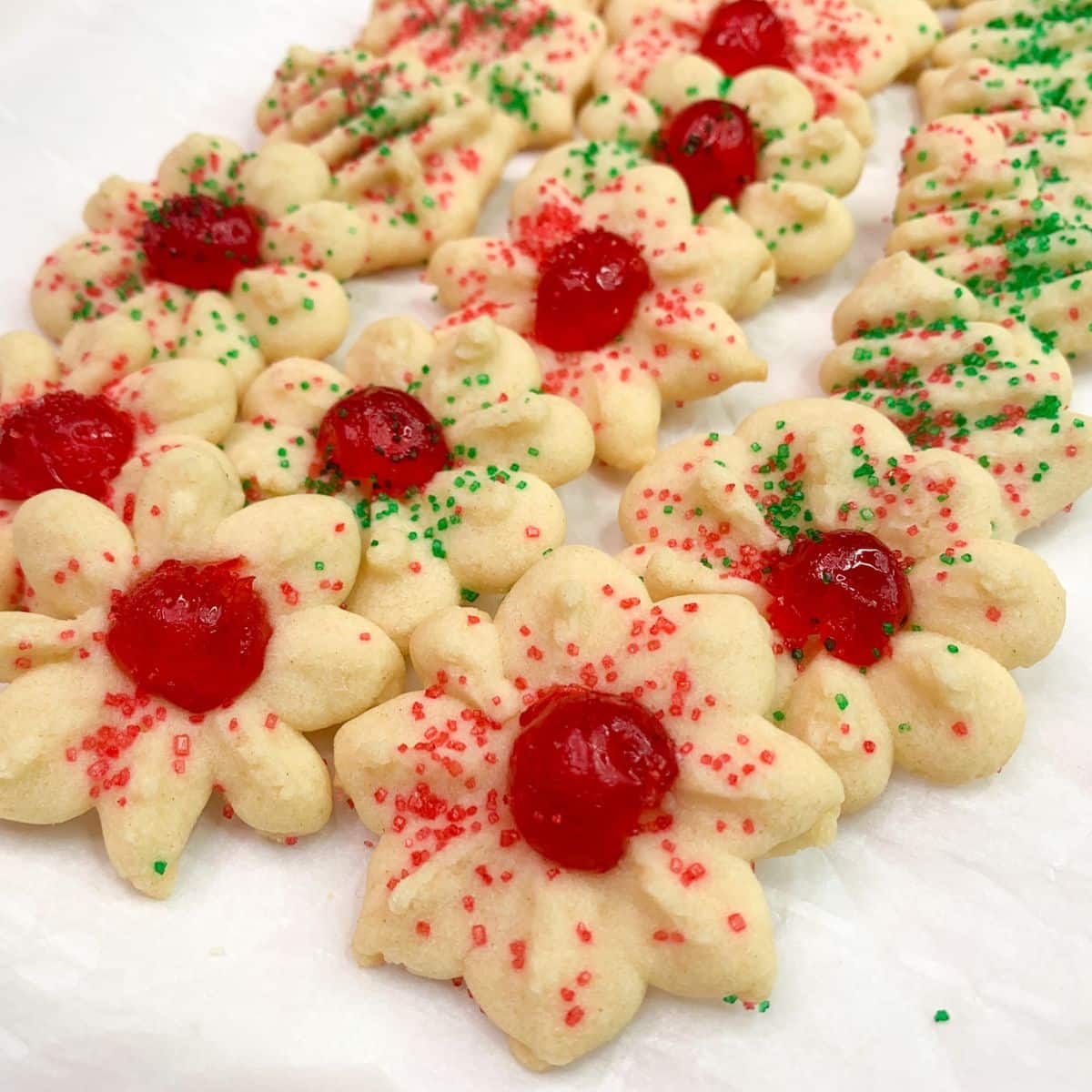 Old fashion spritz cookies with cherries and sprinkles.