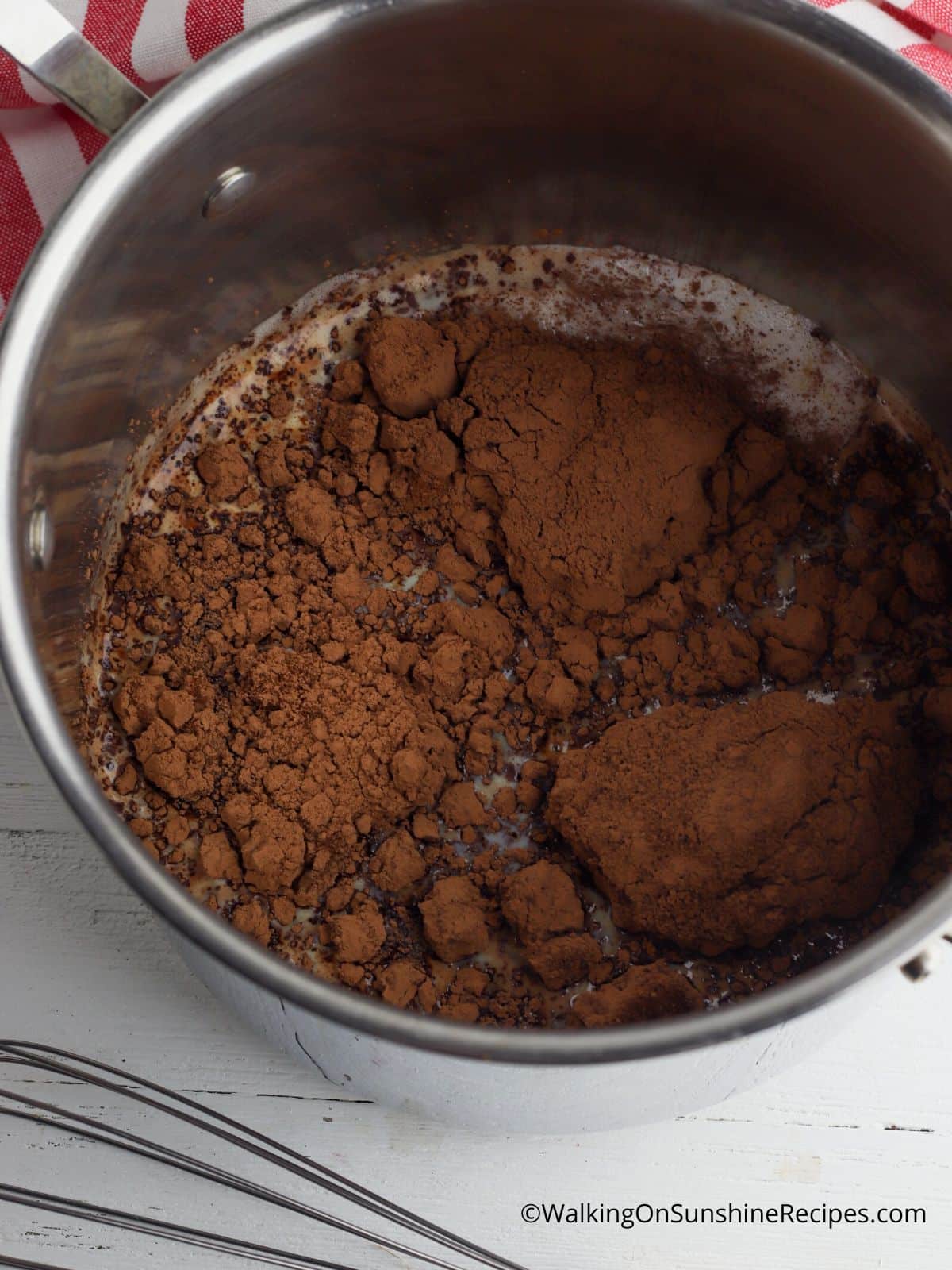 Add cocoa powder to hot milk.