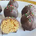 peanut butter balls with melted chocolate and sprinkles