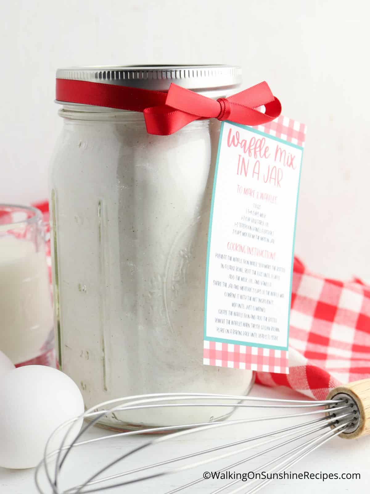 dry waffle mix in mason jar with wire whisk and eggs.